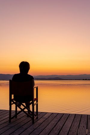 Traveler enjoying sunset sea and mountains