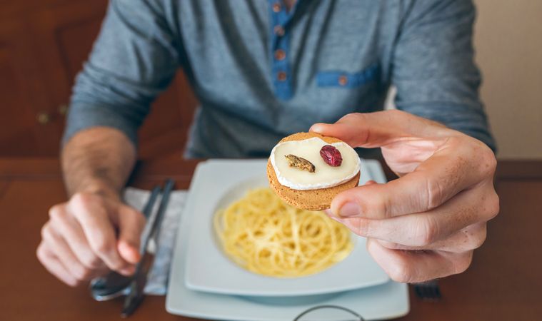 Man eating crickets canape