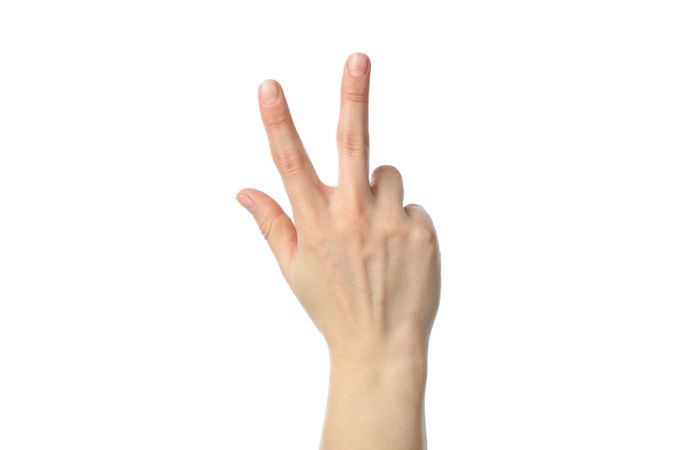 Woman hand showing three fingers, isolated on plain background