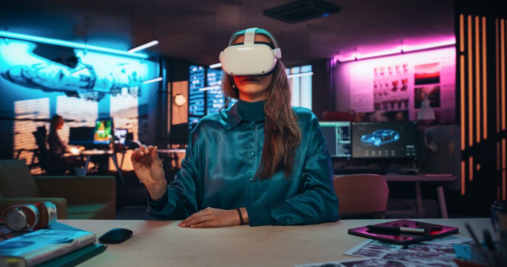 Portrait of Young Adult Female Using Virtual Reality Goggles in Creative Office.