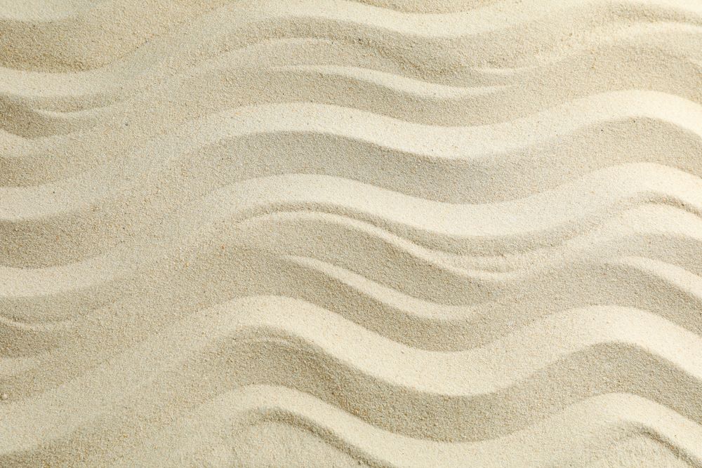 Seamless sand on a whole background, space for text. Summer vacation backdrop
