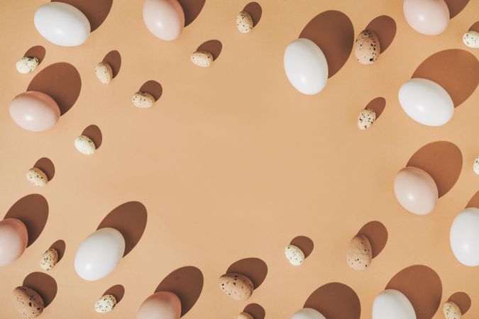 Natural shades of eggs bordering beige background