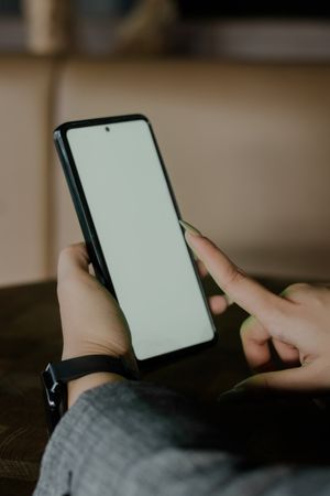 Person Using Smartphone with White Screen, Modern Device Interac