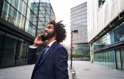 Curly man smiling at street