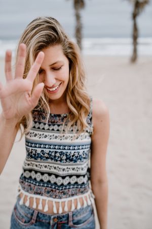 Happy female posing on sandy beach