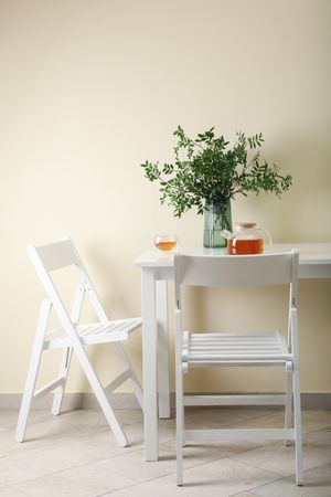 kitchen table with tea and plant in bright room