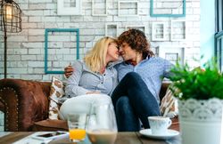 Couple kissing on a sofa