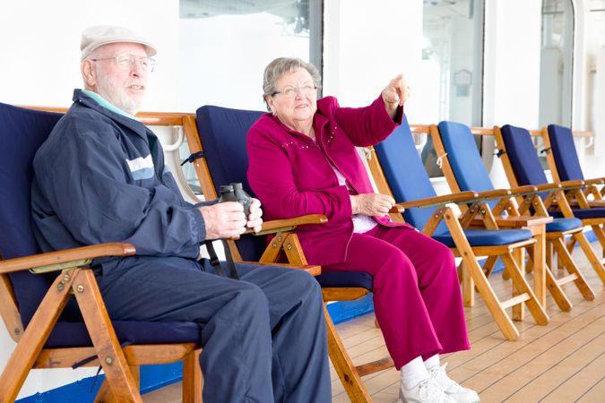 Mature Grey Haired Adult Couple Enjoying The View From Their Passenger Cruise Ship Deck.