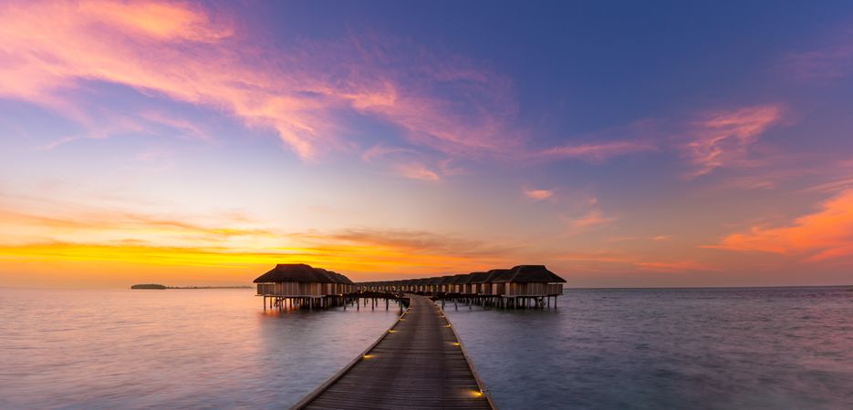 Wide shot of sunset with overwater bungalows