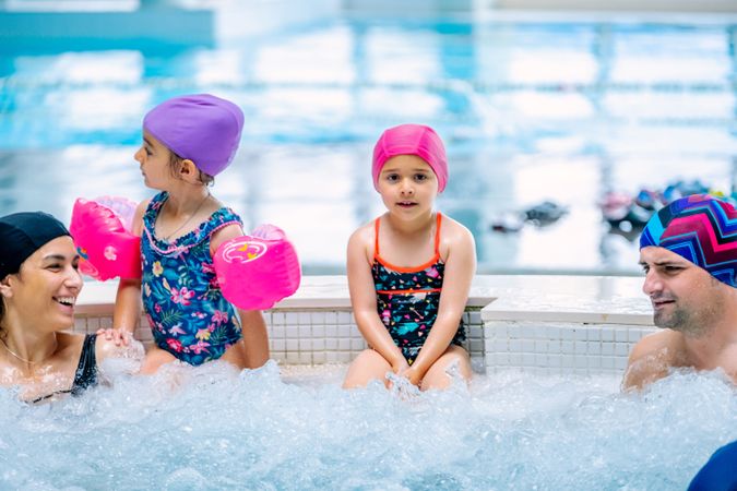 Family relaxing in bubbling pool
