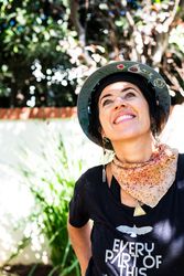 Smiling woman looking up and wearing a hard hat