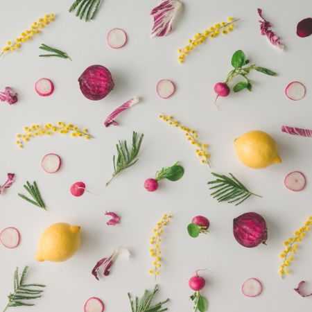 Colorful vegetable pattern made of lemon, beetroot, radish and yellow flowers