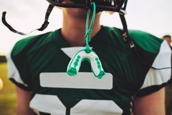 Mouthguard handing off a helmet
