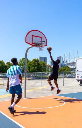 Two men playing basketball outdoor