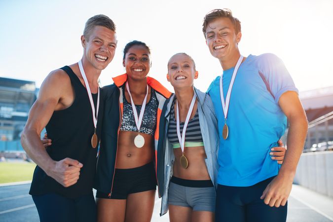 Group of runner with medals winning a competition