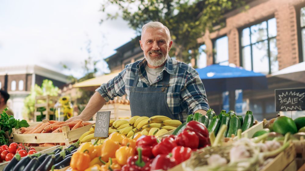 Successful Mature Farmer Posing and Cheerfully Smiling for Camera.