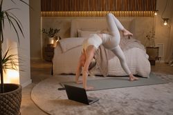 Woman doing gymnastics in modern room