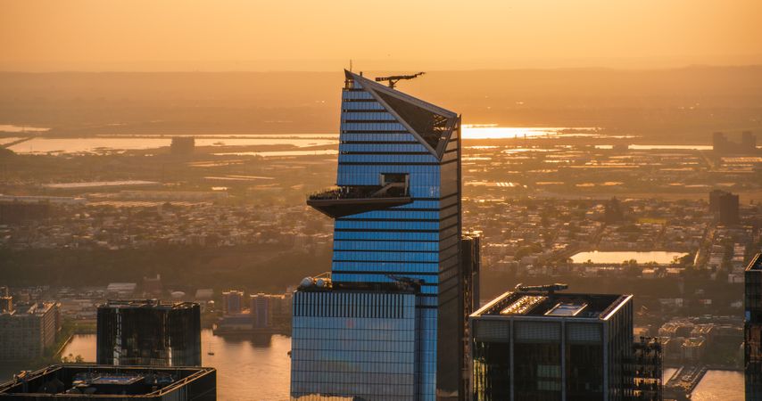 Helicopter Photo Above the Manhattan Skyline, Focusing on 30 Hudson Yards Skyscraper with an Outside Observation Deck. Crowd of Tourists Enjoying Urban Sunset View From a Viewing Platform