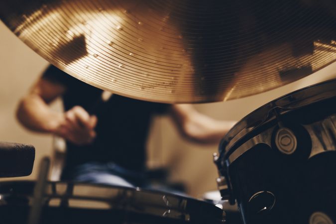 Man with headphones playing on drums