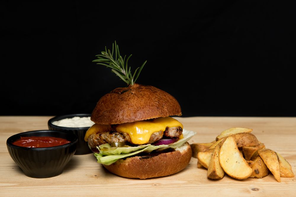 Sauces near burger and fried potato
