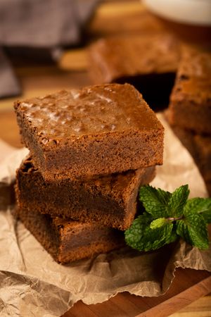 Pile of brownies served with mint garnish