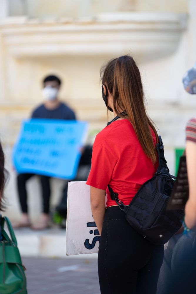 Los Angeles, CA, USA — June 16th, 2020: back view of woman’s head listening to speaker at rally