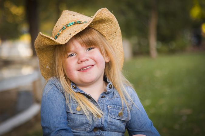 Cute Young Girl Wearing Cowboy Hat Posing for Portrait Outside