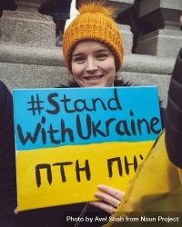 London, England, United Kingdom - March 5 2022: Woman smiling with “Stand with Ukraine” sign 0vn8g0