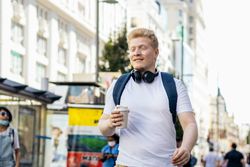 Young Latino man with albinism walking down the city street