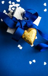 Top view of blue Valentine day concept with giftbox and golden heart