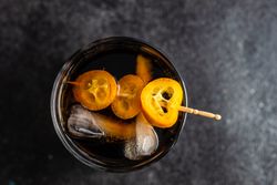 Top view of kumquat slice garnishing cocktail