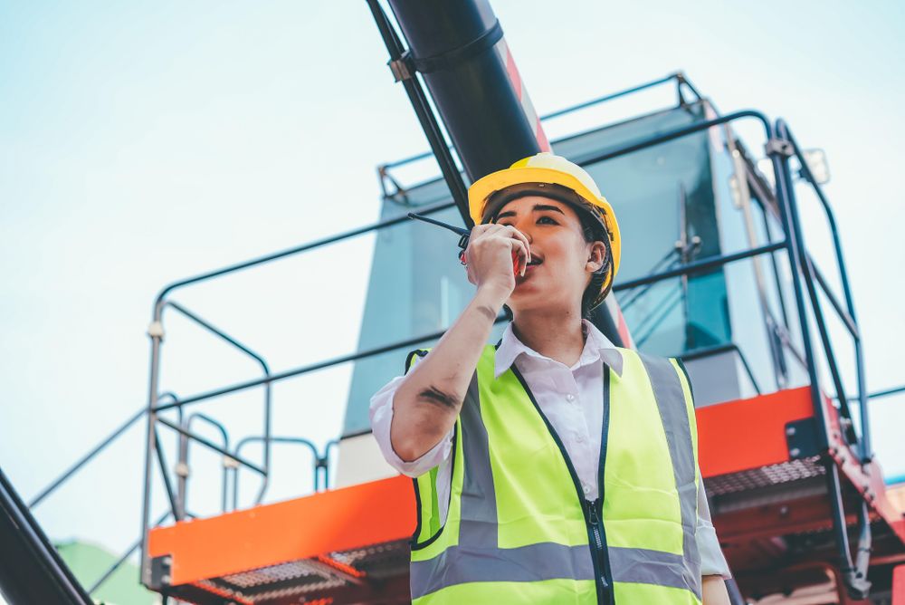 Woman on walking talkie working in logistic business, shipping and delivery