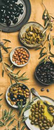Mediterranean meze appetizer on light brown background, vertical composition