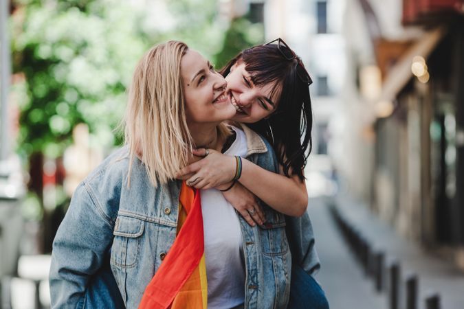 Happy lesbian couple having fun on street