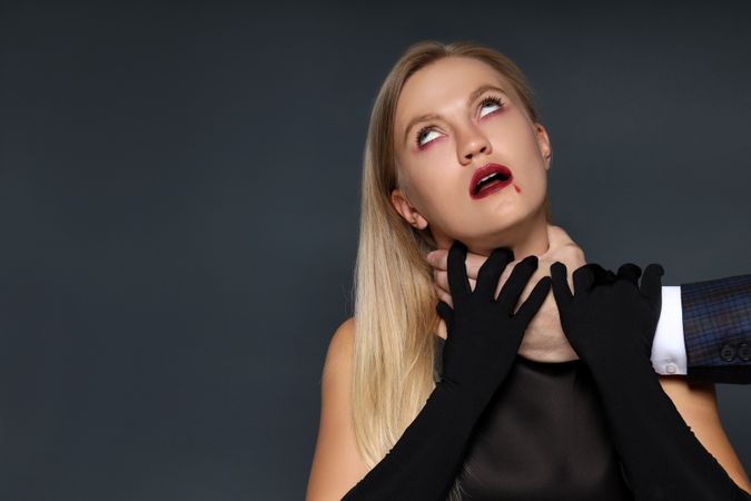 Concept of Halloween, young woman on dark background