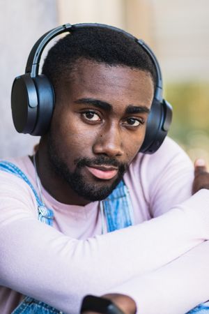 Stylish Black man listening to music in headphones