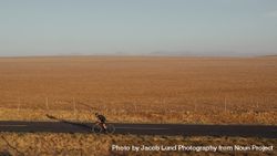 Cyclist riding a bike on asphalt road in countryside 4ZexBn