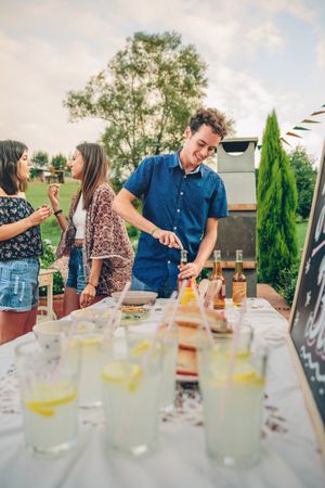 Man opening beer bottle in summer barbecue