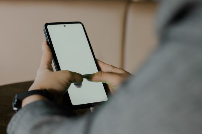 Engrossed Interaction: Person's Hands Navigating a Smartphone Sc