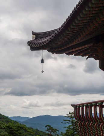 Roof of pagoda against cloudy sky