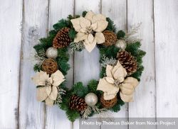 Holiday Poinsettia Christmas wreath on rustic light wood 0LkeRb