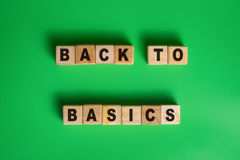 back to basics word on wooden blocks isolated on green background