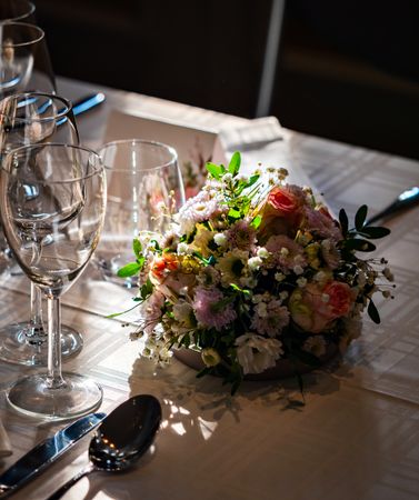 Wedding table decorations. Flowers, figurines of the bride and groom.
