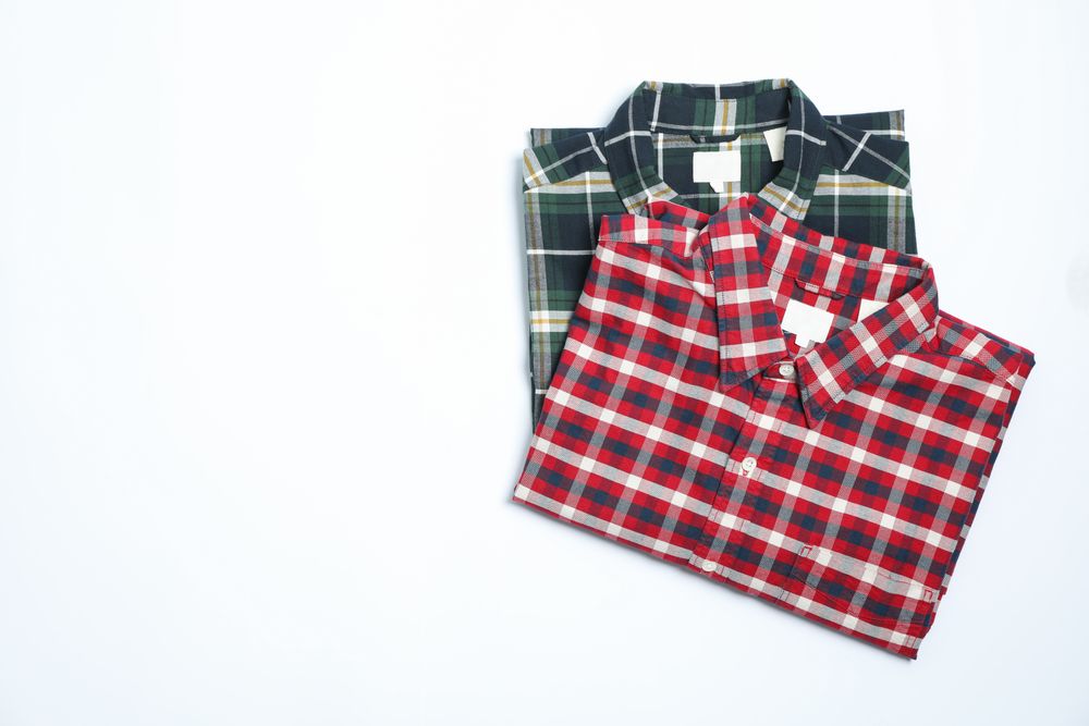 Different beautiful shirts on plain background, copy space