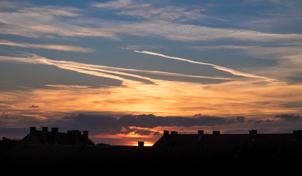 Beautiful colors of sunset over French rooftops