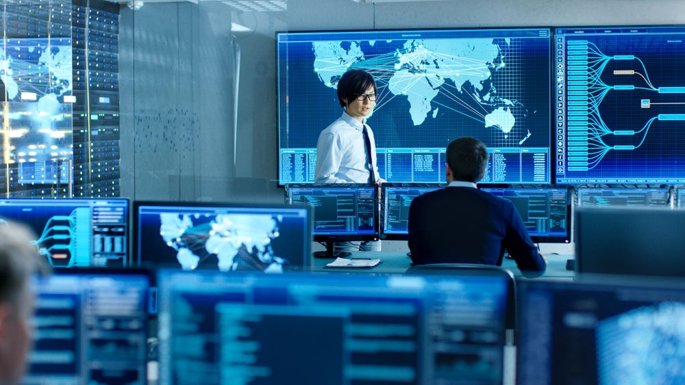 In the System Control Room Chief Engineer Holds a Briefing for Member of the Staff.