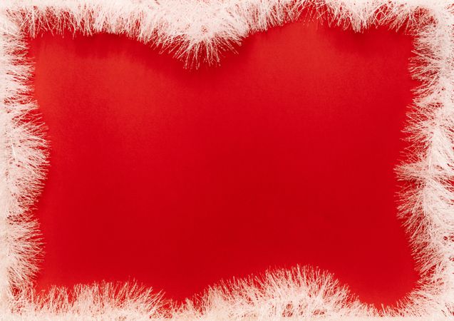 Holiday fir garland frame on red background