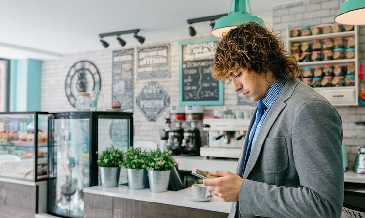 Businessman looking mobile in a cafe