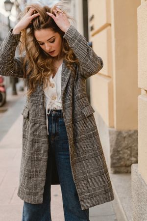 Woman leaning on wall on street