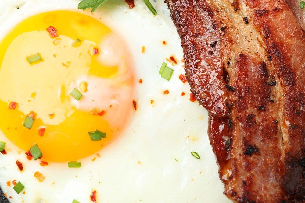 Close up of egg and bacon breakfast